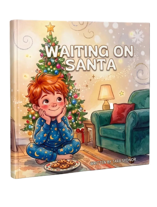 A children's book titled 'Waiting on Santa' by Tara Sydnor, shown standing upright against a black background. The cover features an illustration of a young boy with red hair in blue pajamas sitting cross-legged in front of a decorated Christmas tree, with a teal armchair and lamp in the background.
